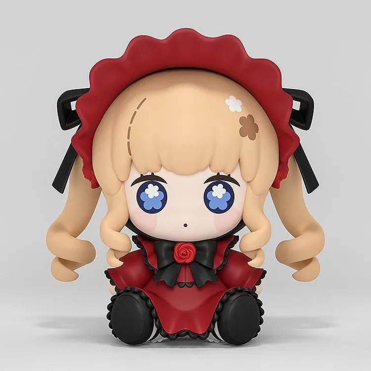 Rozen Maiden Huggy Good Smile Shinku Figure featuring a blonde-haired anime doll with blue eyes, long twin drill curls, a deep red gothic dress, black ribbons, rose decorations, and a matching red bonnet in a cute seated chibi design.