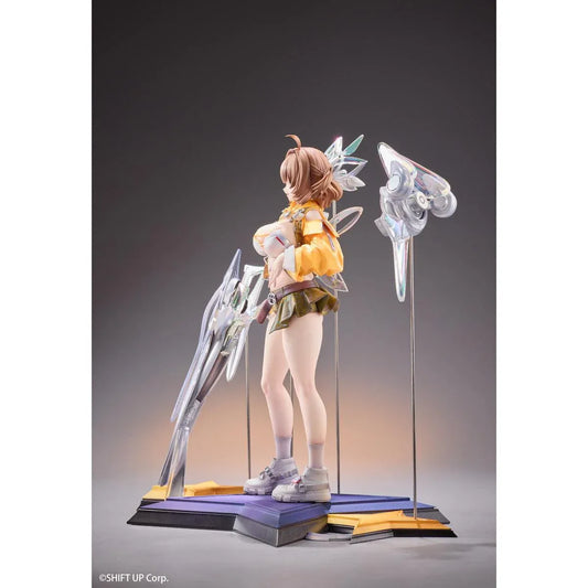 GODDESS OF VICTORY: NIKKE Anis: Star 1/7 Scale Figure featuring a brown-haired anime girl wearing a yellow jacket, white top, olive-green shorts, and sneakers, surrounded by futuristic floating mechanical accessories on a detailed display base.