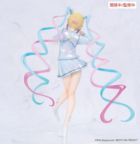 Prototype NEEDY GIRL OVERDOSE Vivit INTERNET ANGEL figure in a pale blue outfit with a yellow bow, spiraling pink-and-turquoise hair, and a peace-sign pose.