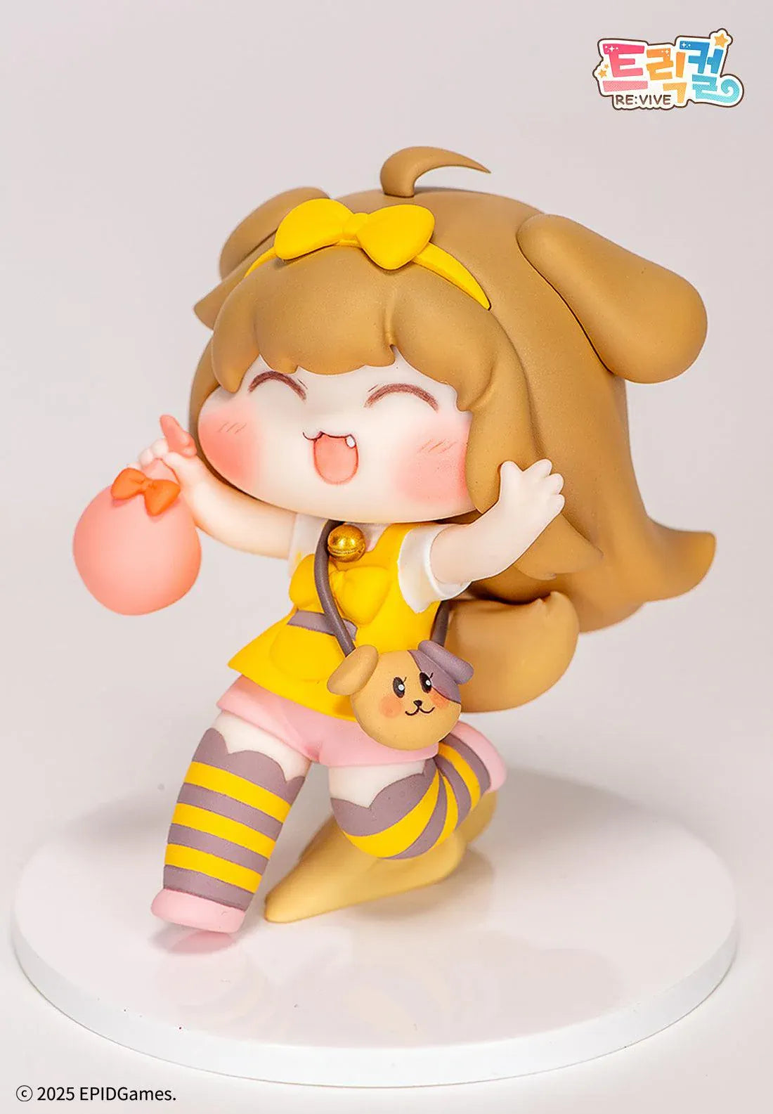 Trickal Chibi Go Butter Non Scale Figure (Rerelease) featuring a cheerful brown-haired character with floppy dog ears, a yellow bow, pink shorts, striped stockings, and a puppy-shaped shoulder bag.