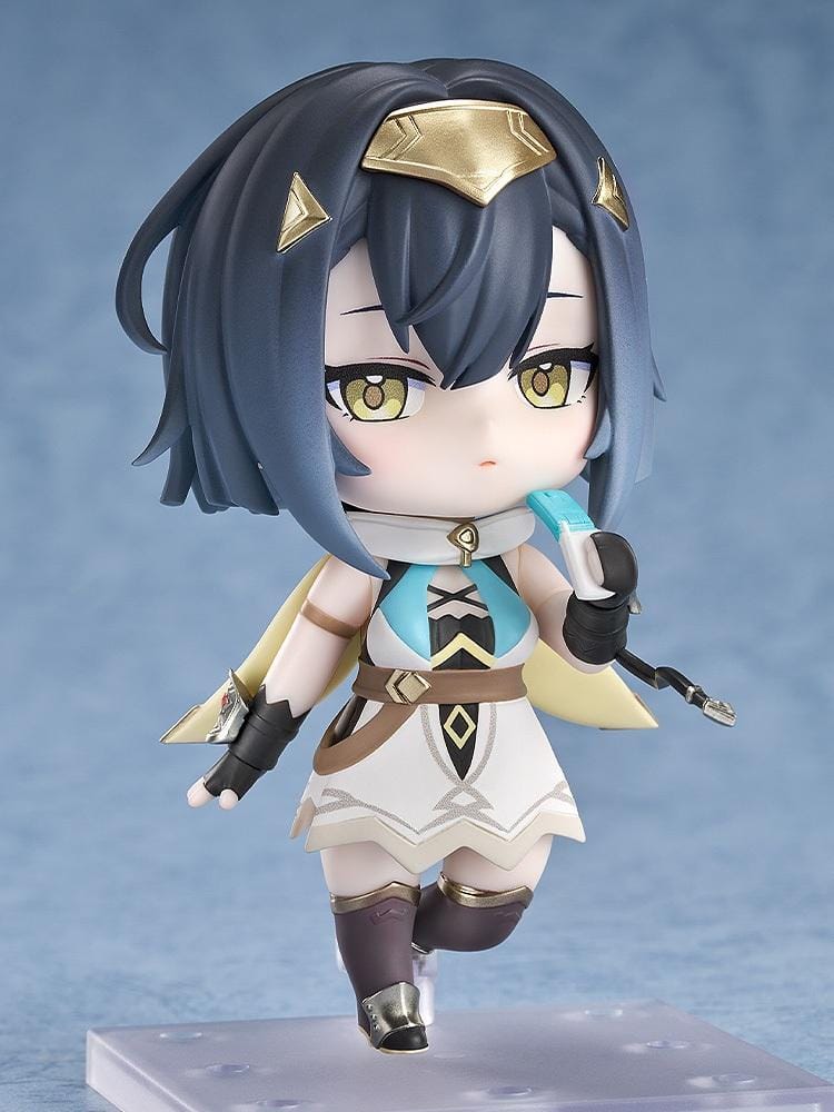 Stella Sora Nendoroid Amber Figure featuring a dark blue-haired anime girl with golden eyes wearing a white and teal outfit with gold accents, black gloves, armored boots, and holding two silver weapons.