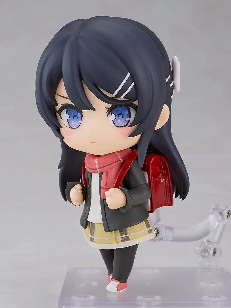 Rascal Does Not Dream Series Nendoroid Knapsack Kid Figure featuring a black-haired anime girl with blue eyes wearing a dark jacket, pink scarf, yellow plaid skirt, black tights, and pink sneakers while carrying a red backpack.