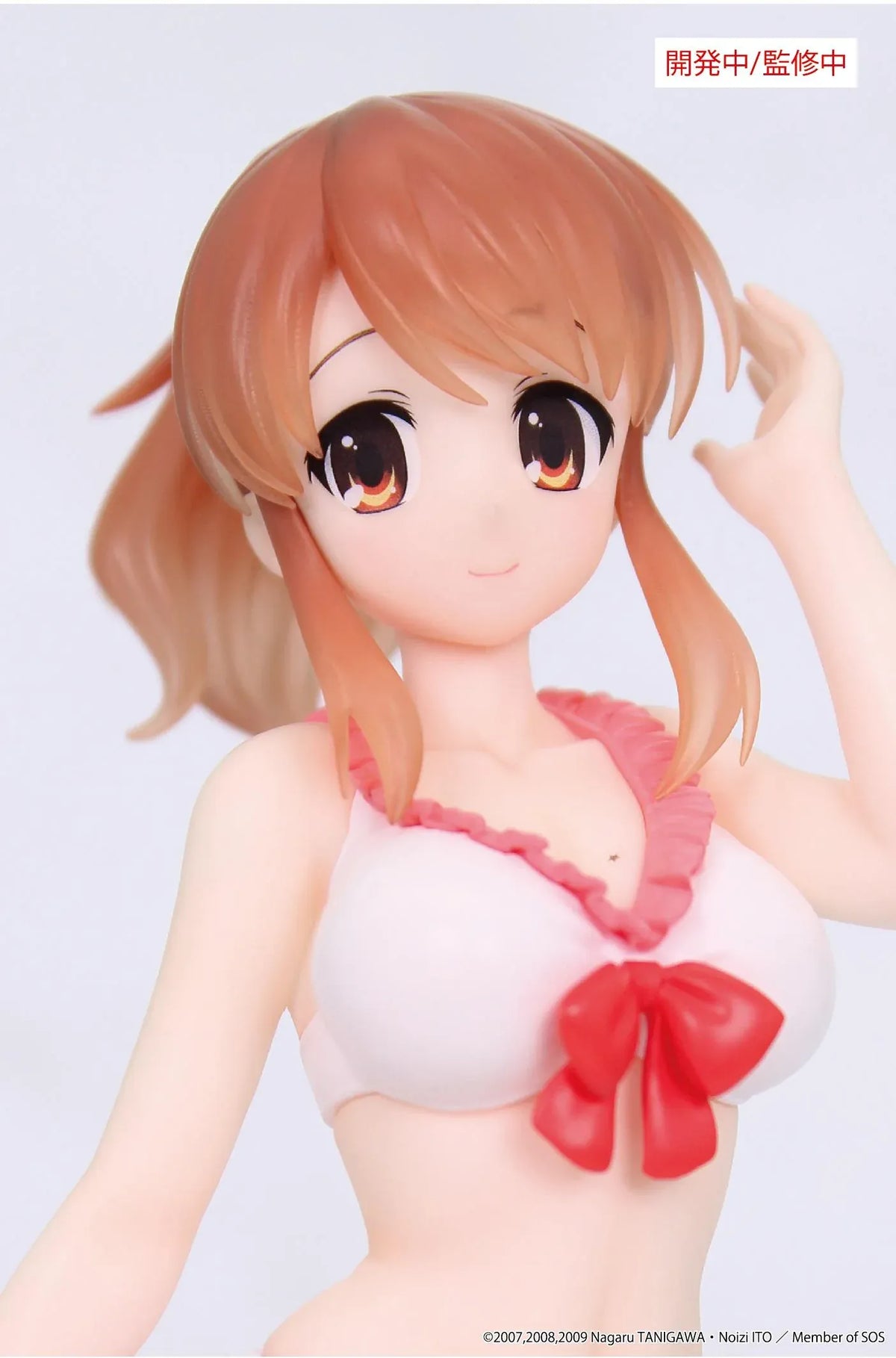 Vivit Mikuru Asahina figure with orange-brown hair, wearing a pink ruffled swimsuit with a red bow, smiling with one hand raised near her bangs.