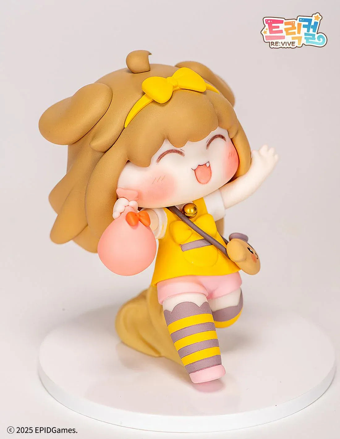 Trickal Chibi Go Butter Non Scale Figure (Rerelease) featuring a cheerful brown-haired character with floppy dog ears, a yellow bow, pink shorts, striped stockings, and a puppy-shaped shoulder bag.