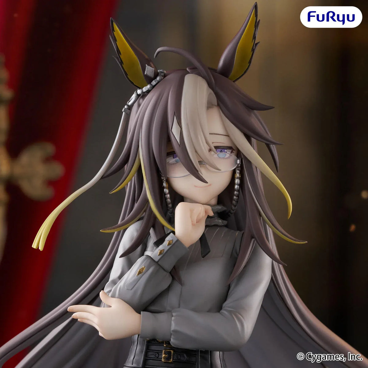 Dream Journey Trio-Try-iT figure wearing glasses, a gray blouse, and dark trousers, with long flowing hair and one hand held near her chin.