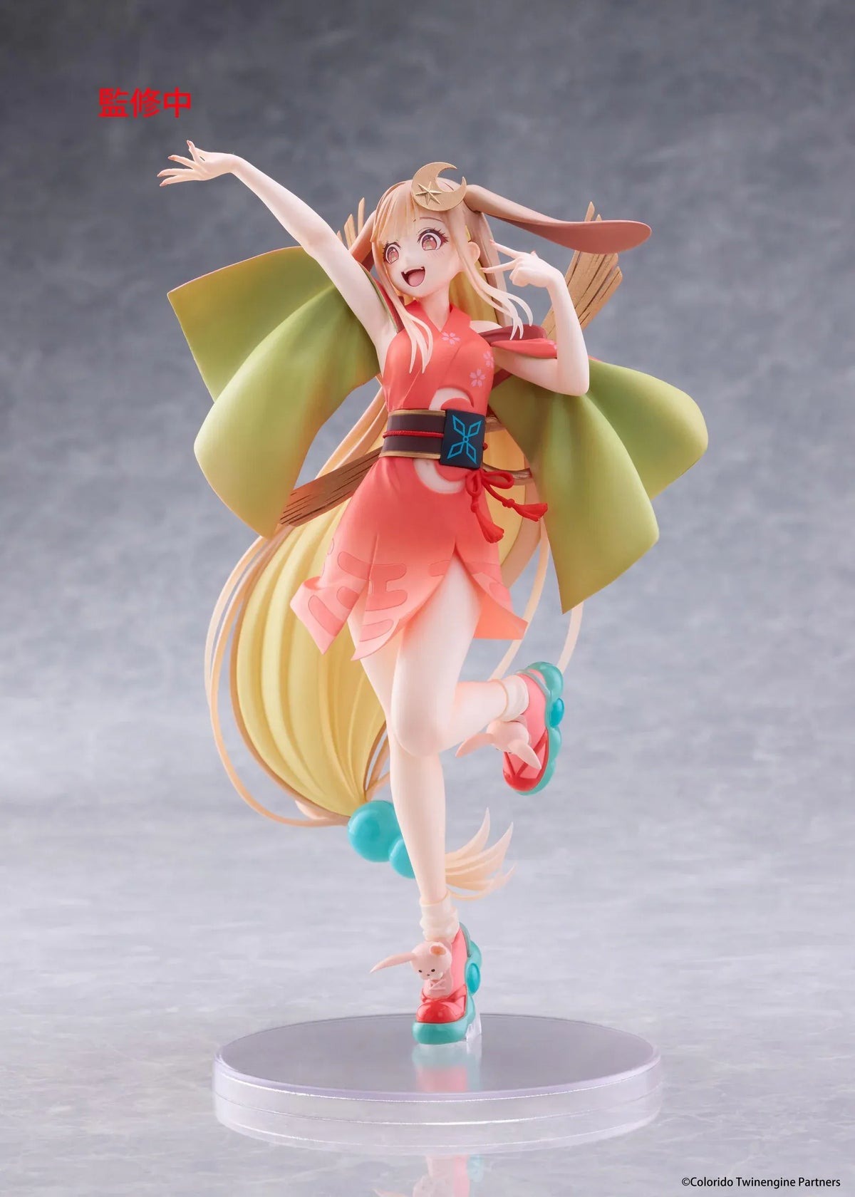Cosmic Princess Kaguya! Kaguya VR Ver. Coreful Figure featuring a blonde-haired anime girl with pink eyes, long flowing hair, bunny ears, a crescent moon hair accessory, a coral-pink outfit with green sleeves, and colorful shoes in an energetic pose on a transparent circular base.
