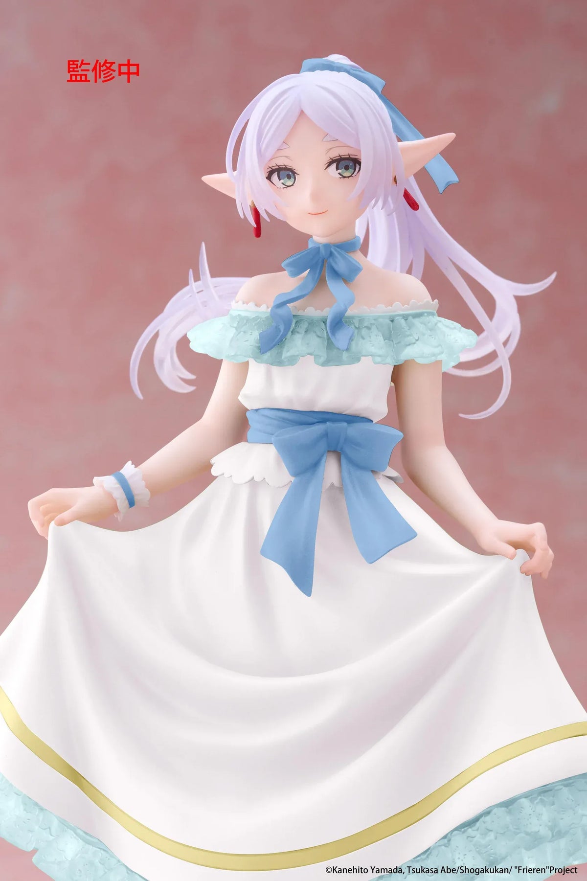 Frieren Beyond Journey's End Frieren Party Dress Ver. Coreful Figure (Rerelease) featuring a silver-white-haired elf with green eyes wearing an elegant white off-the-shoulder dress with light-blue ruffles, golden trim, blue ribbons, and matching heels while gracefully holding her skirt on a transparent circular base.