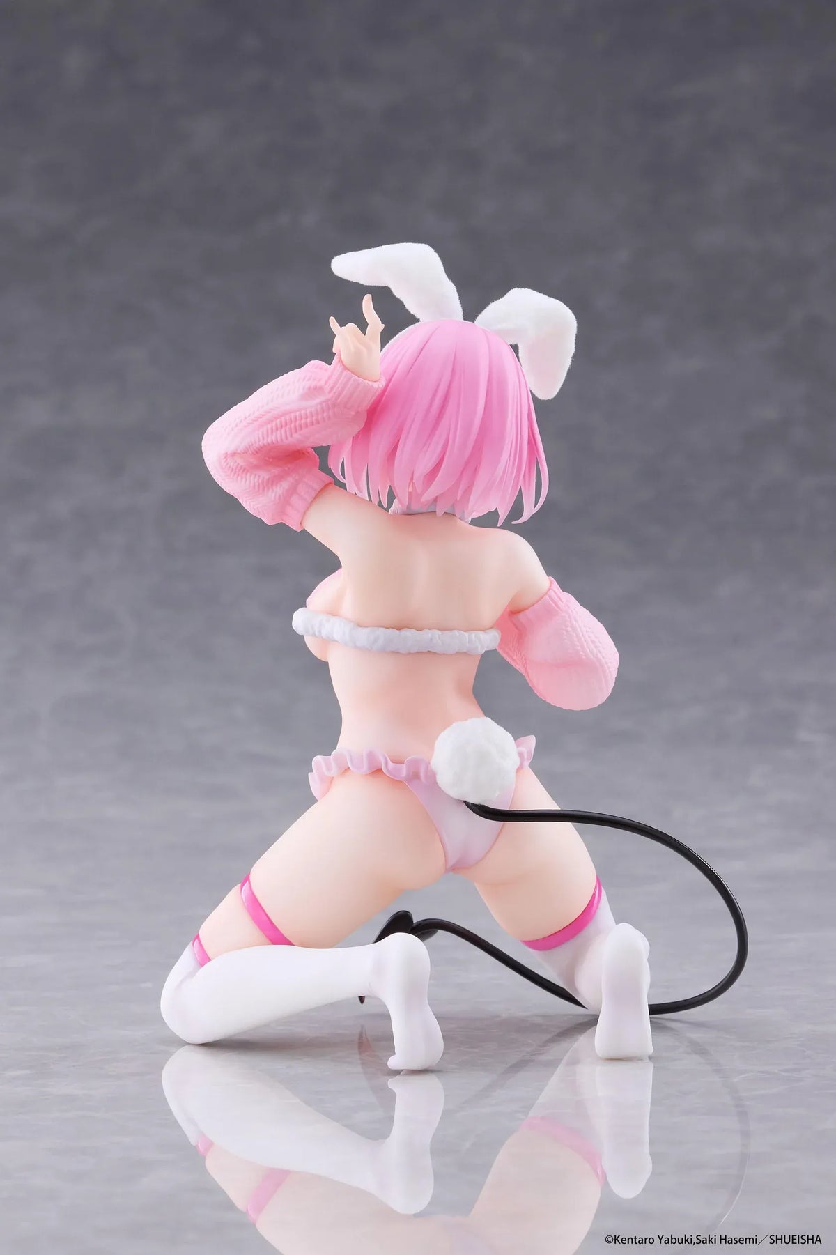 To Love-Ru Darkness MOFLOCK Momo Fluffy Bunny Ver. Figure featuring a pink-haired anime girl with pink eyes, white bunny ears, a pink fluffy bunny outfit, matching sleeves, white thigh-high stockings, and a black devil tail in a playful kneeling pose.