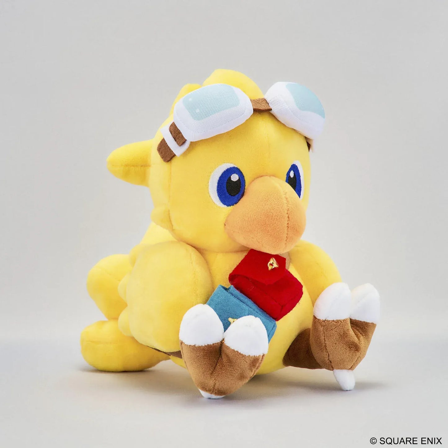 Final Fantasy Chocobo Chocobo and the Airship Ver. Plush with yellow Chocobo, pilot goggles, travel bag, blue embroidered eyes, and seated plush design