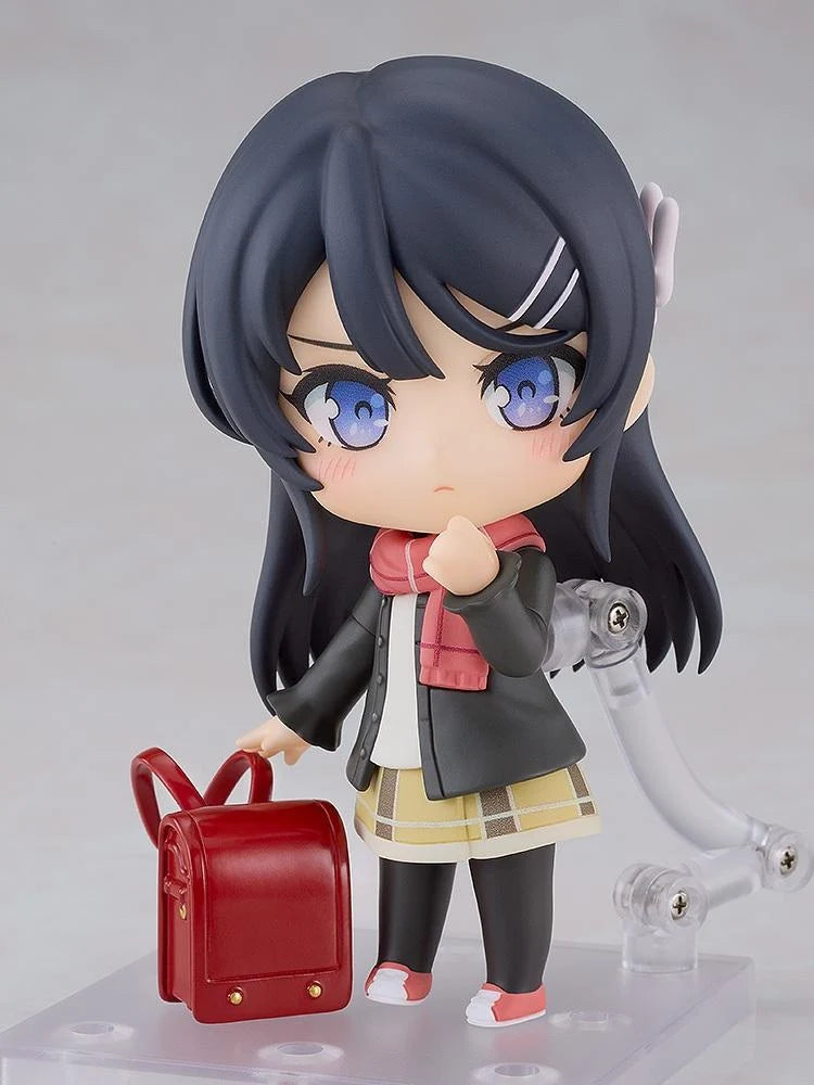 Rascal Does Not Dream Series Nendoroid Knapsack Kid Figure featuring a black-haired anime girl with blue eyes wearing a dark jacket, pink scarf, yellow plaid skirt, black tights, and pink sneakers while carrying a red backpack.