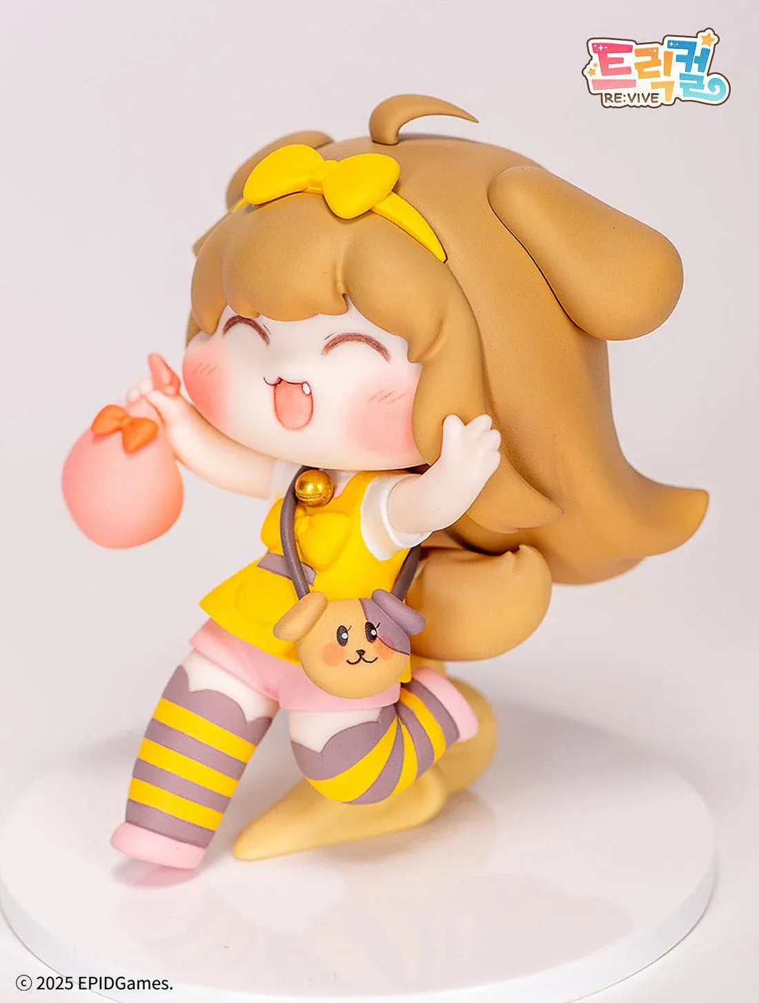 Trickal Chibi Go Butter Non Scale Figure (Rerelease) featuring a cheerful brown-haired character with floppy dog ears, a yellow bow, pink shorts, striped stockings, and a puppy-shaped shoulder bag.