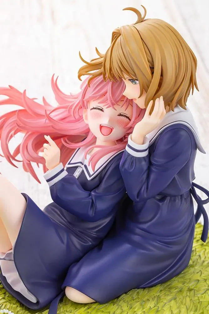 I Want to Love You Till Your Dying Day Sheena & Mimi 1/8 Scale Figure featuring pink-haired Sheena smiling with her eyes closed while leaning against blonde-haired Mimi. Both wear navy-blue school-inspired dresses and sit together on a textured grassy display base decorated with a white daisy flower crown.