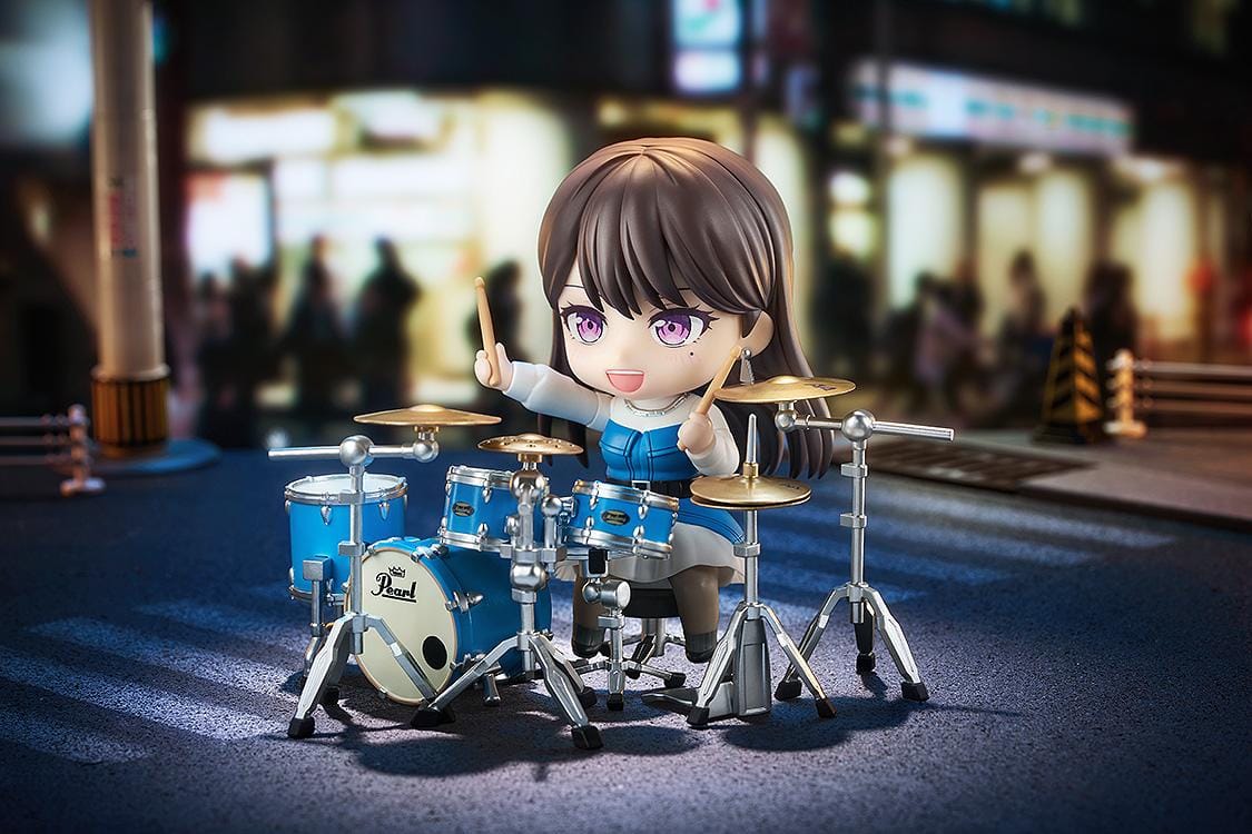 BanG Dream Nendoroid Taki Shiina Figure featuring Taki in a chibi-style design with long dark hair, purple eyes, blue outfit, and drumstick accessory.