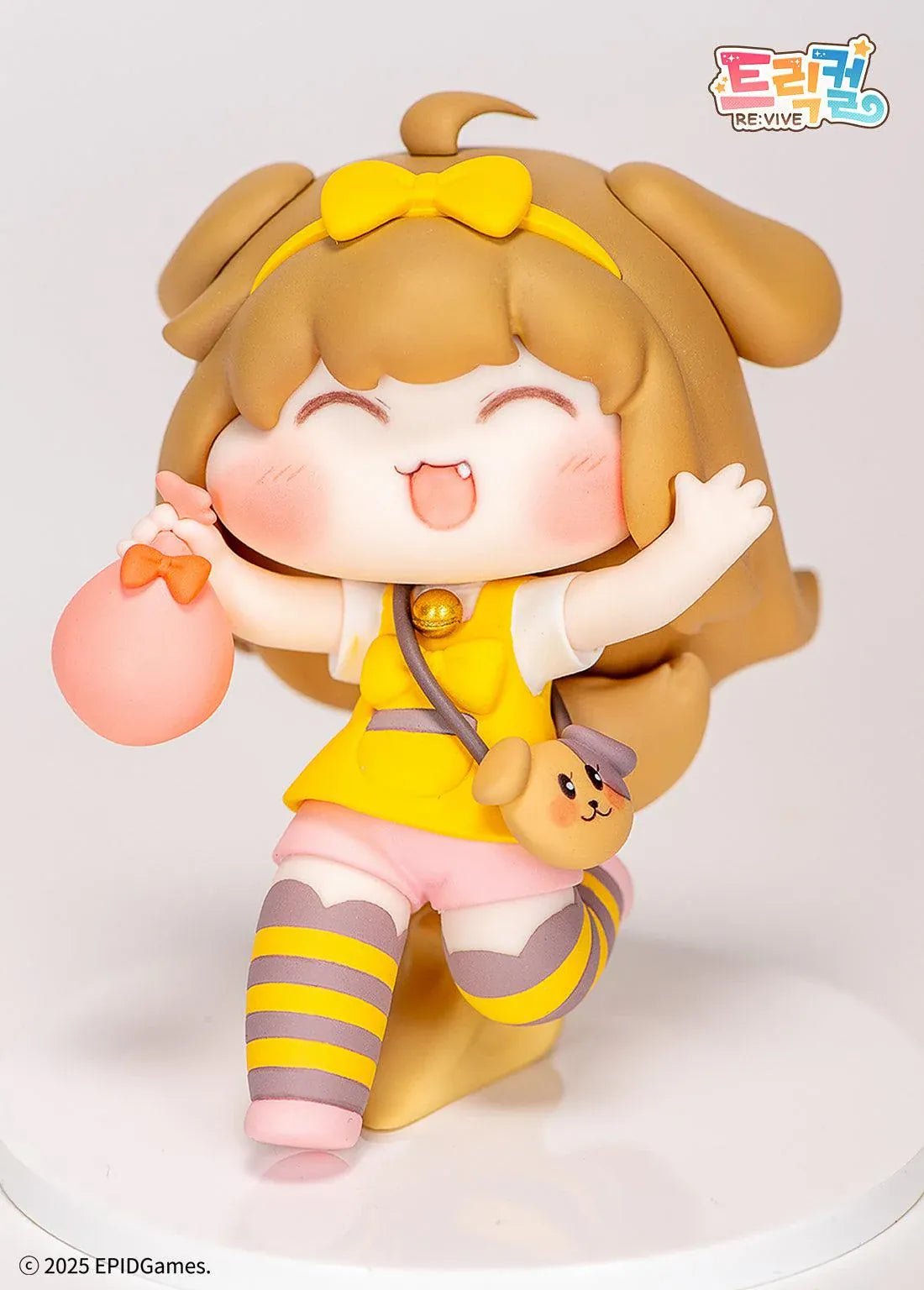 Trickal Chibi Go Butter Non Scale Figure (Rerelease) featuring a cheerful brown-haired character with floppy dog ears, a yellow bow, pink shorts, striped stockings, and a puppy-shaped shoulder bag.