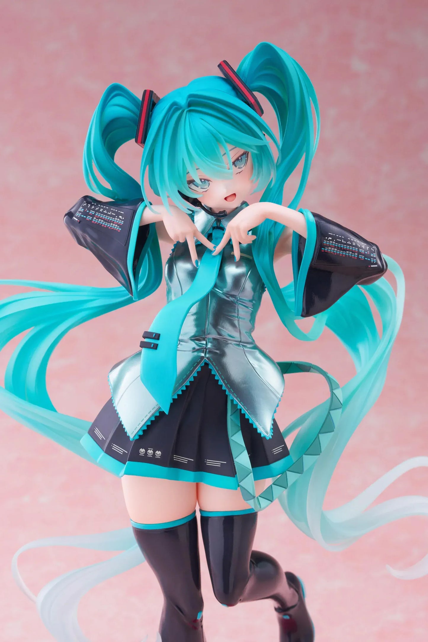 Hatsune Miku T-Most figure with flowing twin tails, classic Vocaloid outfit, and pink heart-shaped display base