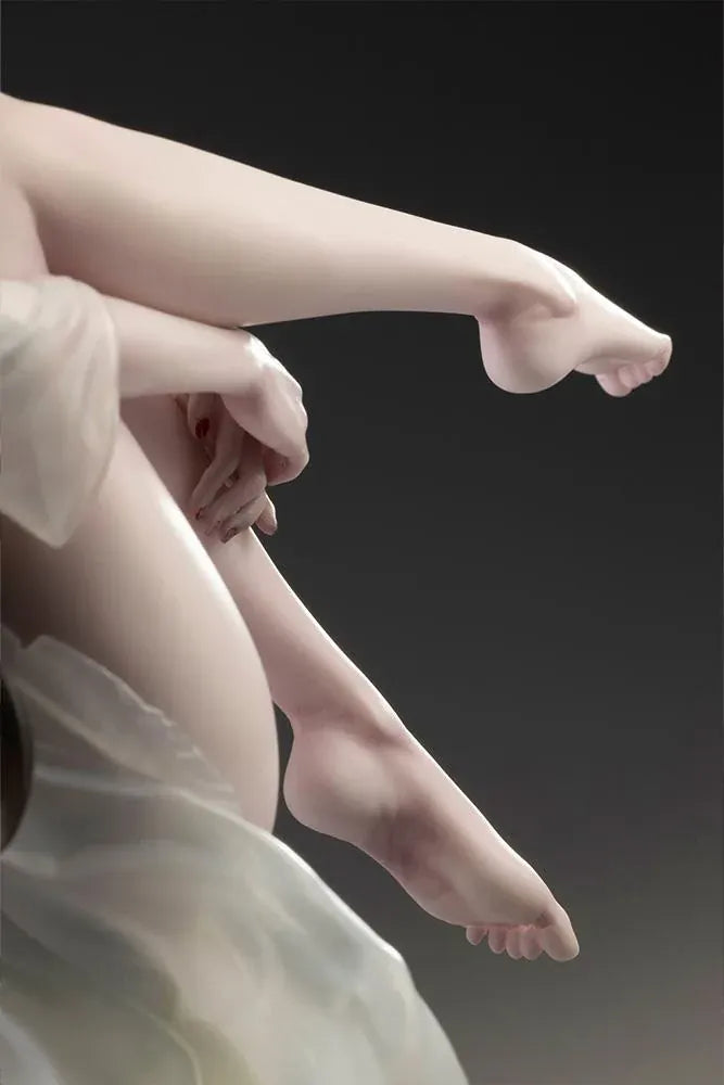 Sadako BISHOUJO Sadako 1/7 Scale Figure (Rerelease) featuring a long black-haired horror character wearing a flowing white dress, seated above a pile of VHS tapes with tangled black film ribbons.