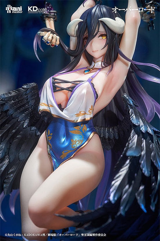 "Collectible figure of Albedo in a 'Restrained Version' pose with raised arms holding chains, adorned with black raven wings, wearing a blue and white costume with ornamental details, and sitting atop a circular base with decorative elements."