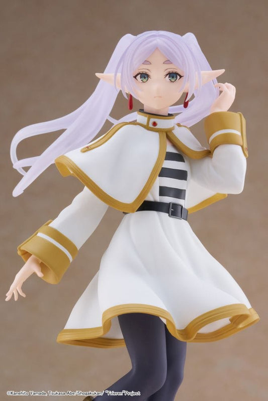 Frieren Coreful figure from Frieren: Beyond Journey’s End in white and gold cloak with lavender hair and boots.