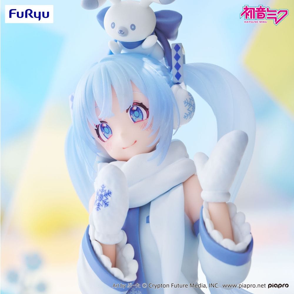 Snow Miku (Sky Town 10th Ver.) figure sitting in a kneeling pose with mittens and scarf, wearing pastel blue and white winterwear.