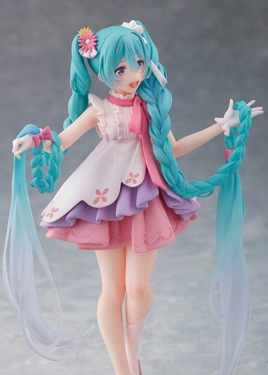 Hatsune Miku Wonderland Figure in Rapunzel theme, featuring Miku with turquoise braided hair and a pink and white dress, dancing joyfully on a clear base.