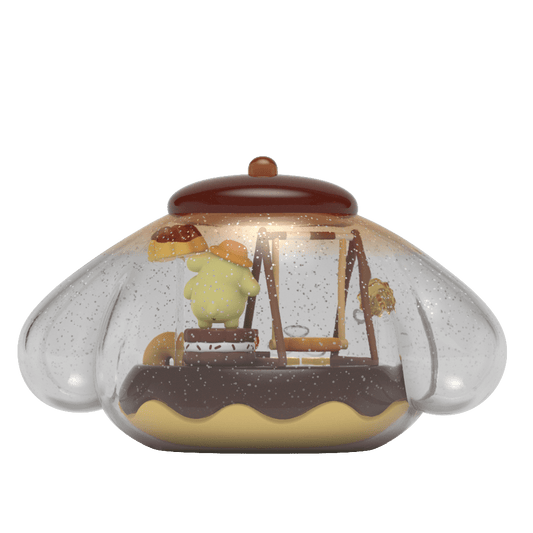 Kandyland: Sanrio Pompompurin figure inside a clear globe filled with glitter, featuring Pompompurin on candy-themed playground equipment, topped with a red cap, creating a whimsical and playful scene.