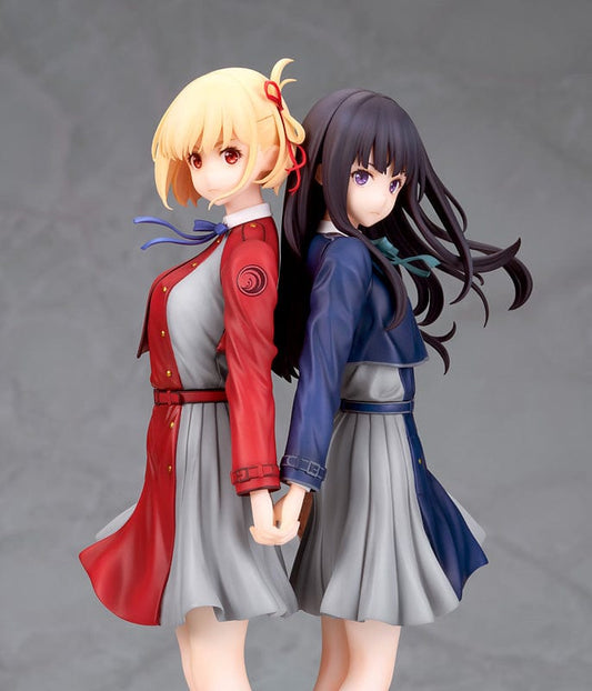 Chisato Nishikigi and Takina Inoue from 'Lycoris Recoil' standing back-to-back in a 1/8 scale figure, dressed in their school uniforms on a branded display base