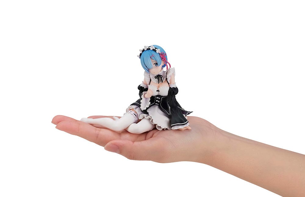 Detailed figure of Rem from Re:Zero, dressed as a maid in black and white, with blue hair and a floral headband, lying down with a gentle expression, encapsulating her Melty Princess persona in Tenohira size.