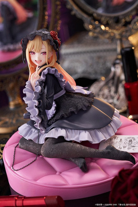 My Dress-Up Darling AMP+ Marin Kitagawa (Dress of Shizuku Kuroe Ver.) Figure, displayed in a gothic lolita dress, sitting playfully on a pink cushion base, perfect for fans and collectors of unique character figures.