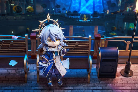Nendoroid Doll Sunday from Honkai: Star Rail, wearing ornate robes and holding a book with a golden halo above his head.