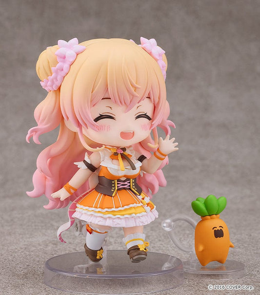 Hololive Production Nendoroid No.2502 Momosuzu Nene figure featuring Nene in her colorful idol outfit, smiling with her hands raised in excitement.