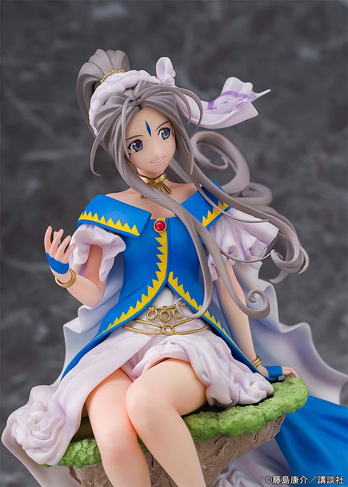 Oh My Goddess! Belldandy figure seated on a rock, dressed in a flowing blue and white gown with gold accents, exuding elegance and grace.