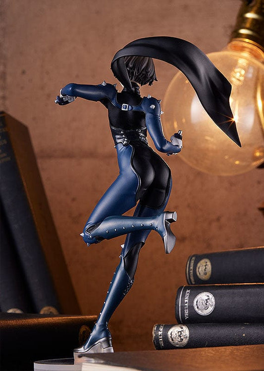 Persona POP UP PARADE Queen figure in action pose, wearing a tight blue bodysuit with leather corset and metallic accents, complete with a flowing black cape and combat boots, set on a clear stand against a gray backdrop.