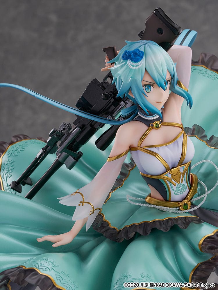 Sword Art Online Sinon (Crystal Dress Ver.) 1/7 Scale Shibuya Scramble Figure in aquamarine gown with gold accents, dynamic pose, and rocky base.