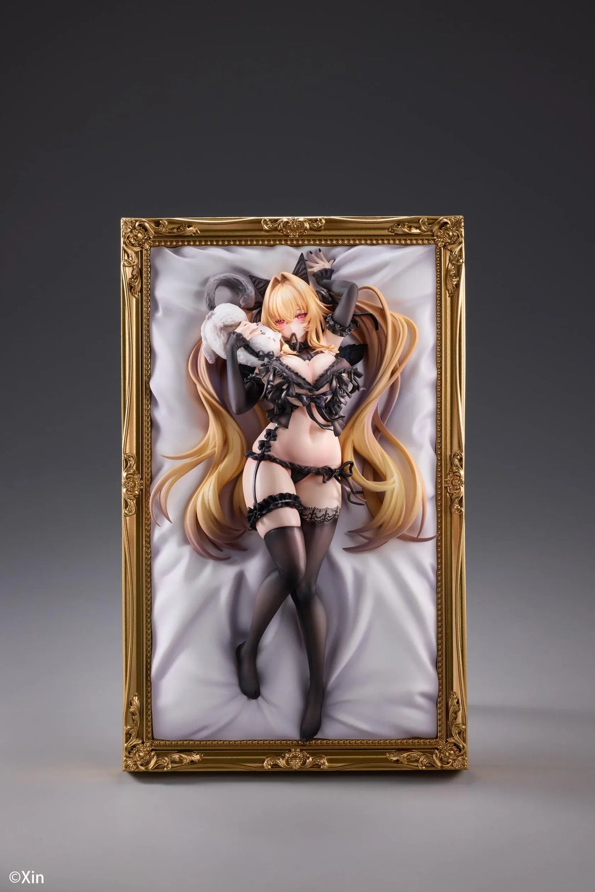 Stella Black Cat Ver. Deluxe Edition 1/7 Scale Figure illustrated by Xin, featuring a blonde-haired catgirl with red eyes, black lace lingerie, cat ears, and thigh-high stockings displayed in an ornate golden frame with a matching illustrated wall scroll.