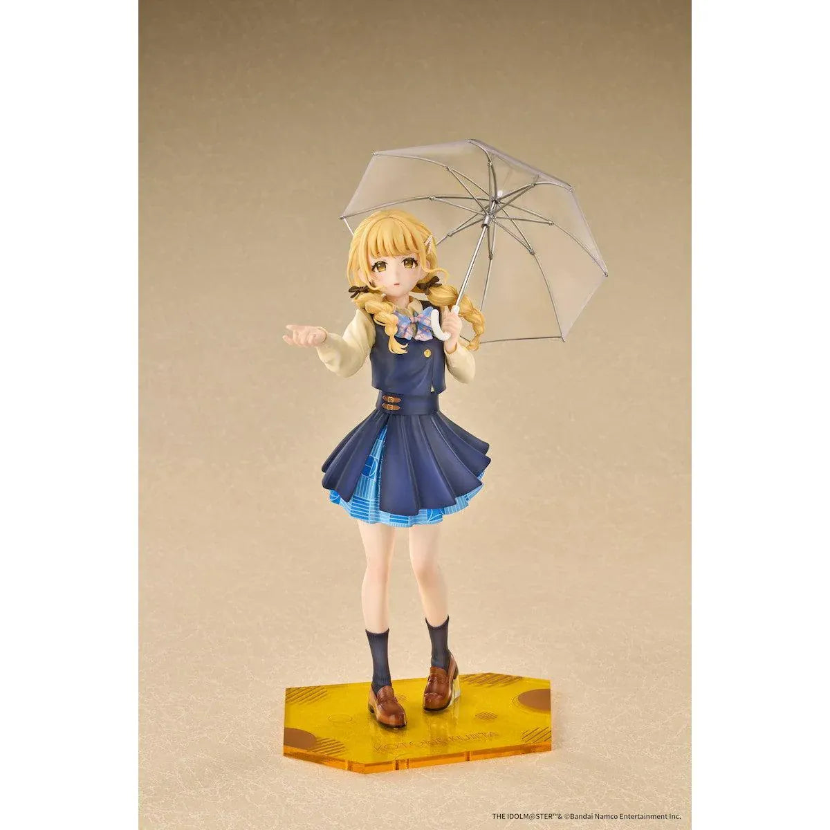 Gakuen iDOLM@STER Kotone Fujita Ameagari no Iris Before Special Training Ver. 1/7 Scale Figure featuring a blonde-haired anime girl with twin braids wearing a navy-blue school uniform and holding a transparent umbrella on a yellow display base.