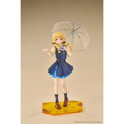 Gakuen iDOLM@STER Kotone Fujita Ameagari no Iris Before Special Training Ver. 1/7 Scale Figure featuring a blonde-haired anime girl with twin braids wearing a navy-blue school uniform and holding a transparent umbrella on a yellow display base.