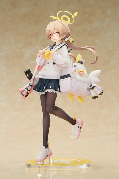 Blue Archive Hifumi figure smiling with one foot lifted, wearing a white cardigan and navy skirt, carrying a bird-themed bag and rifle on a yellow base.