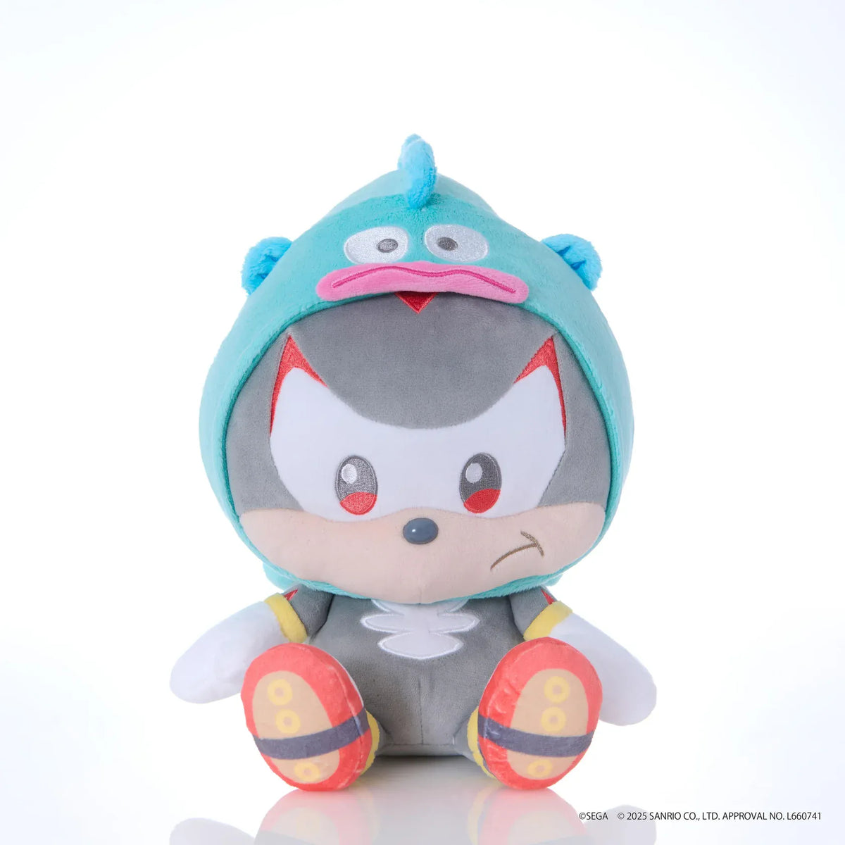 Sonic & Friends x Sanrio Shadow medium plush wearing an aqua Hangyodon hood with wide eyes, pink lips, and side fins.