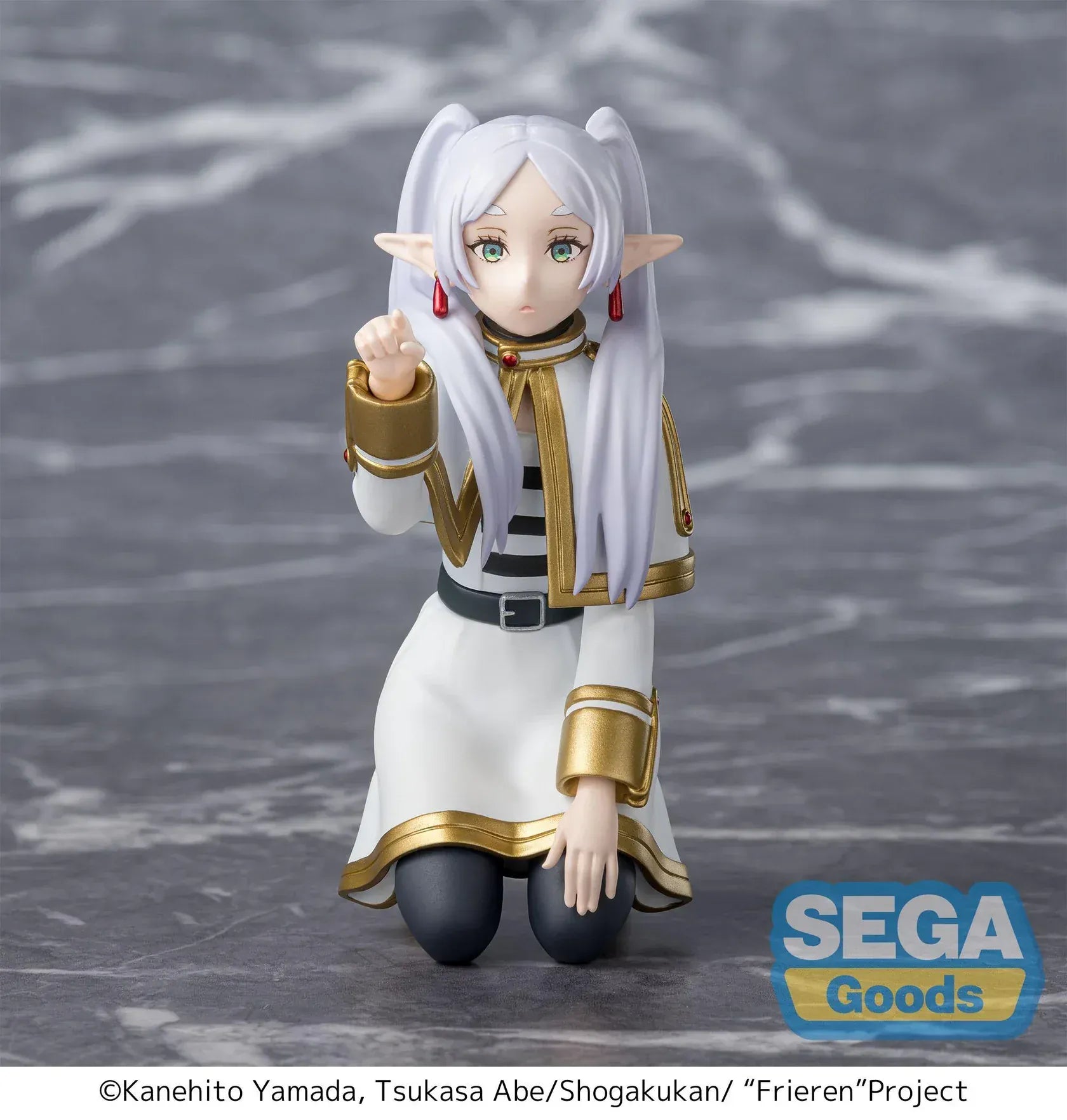Perching figure of Frieren from Frieren: Beyond Journey’s End kneeling on a stone-like base, reaching forward to poke something, with long silver hair, elf ears, and a white-and-gold outfit.