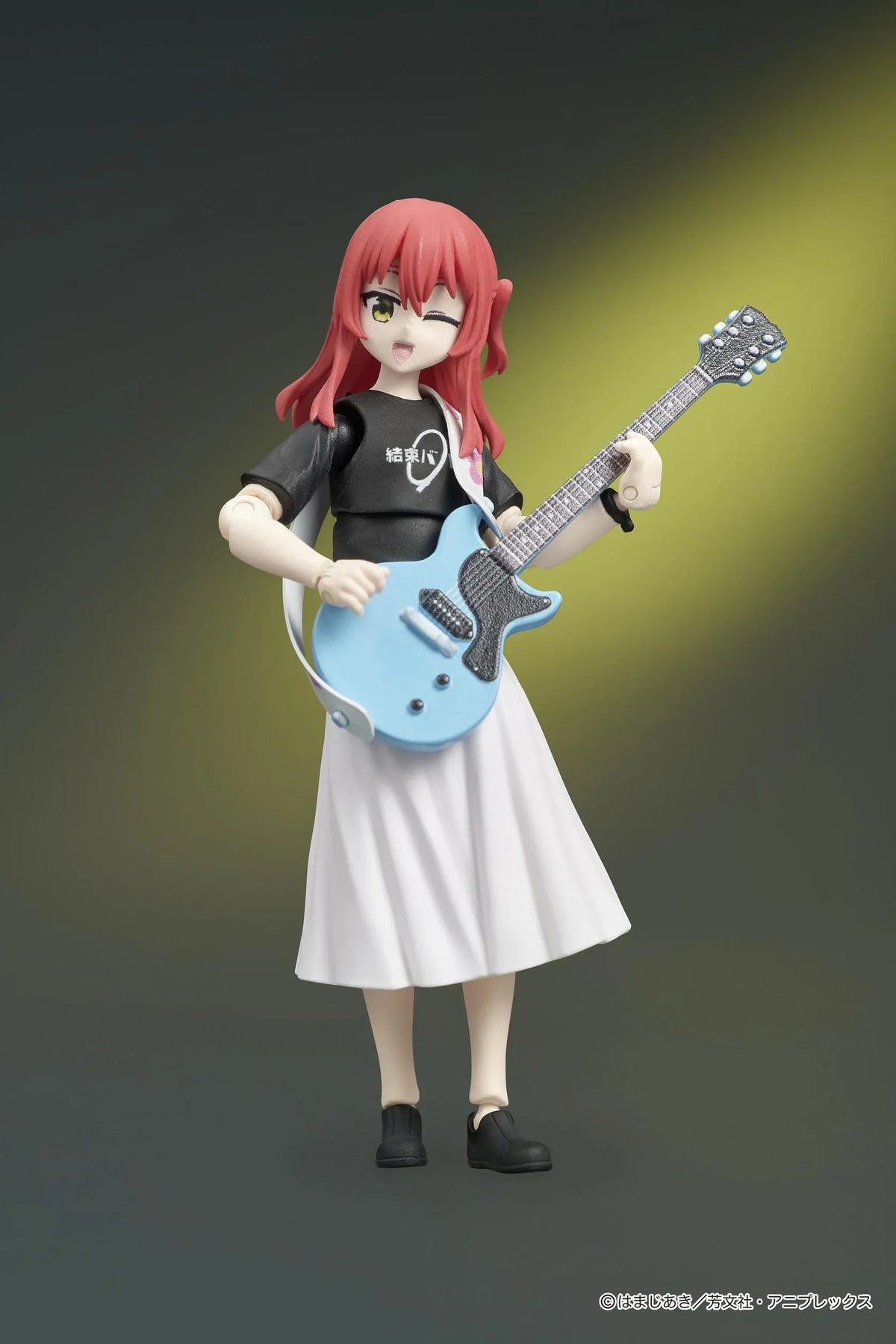 Bocchi the Rock! DIGACTION Ikuyo Kita figure winking while holding a light blue guitar, wearing a black band T-shirt and white pleated skirt.