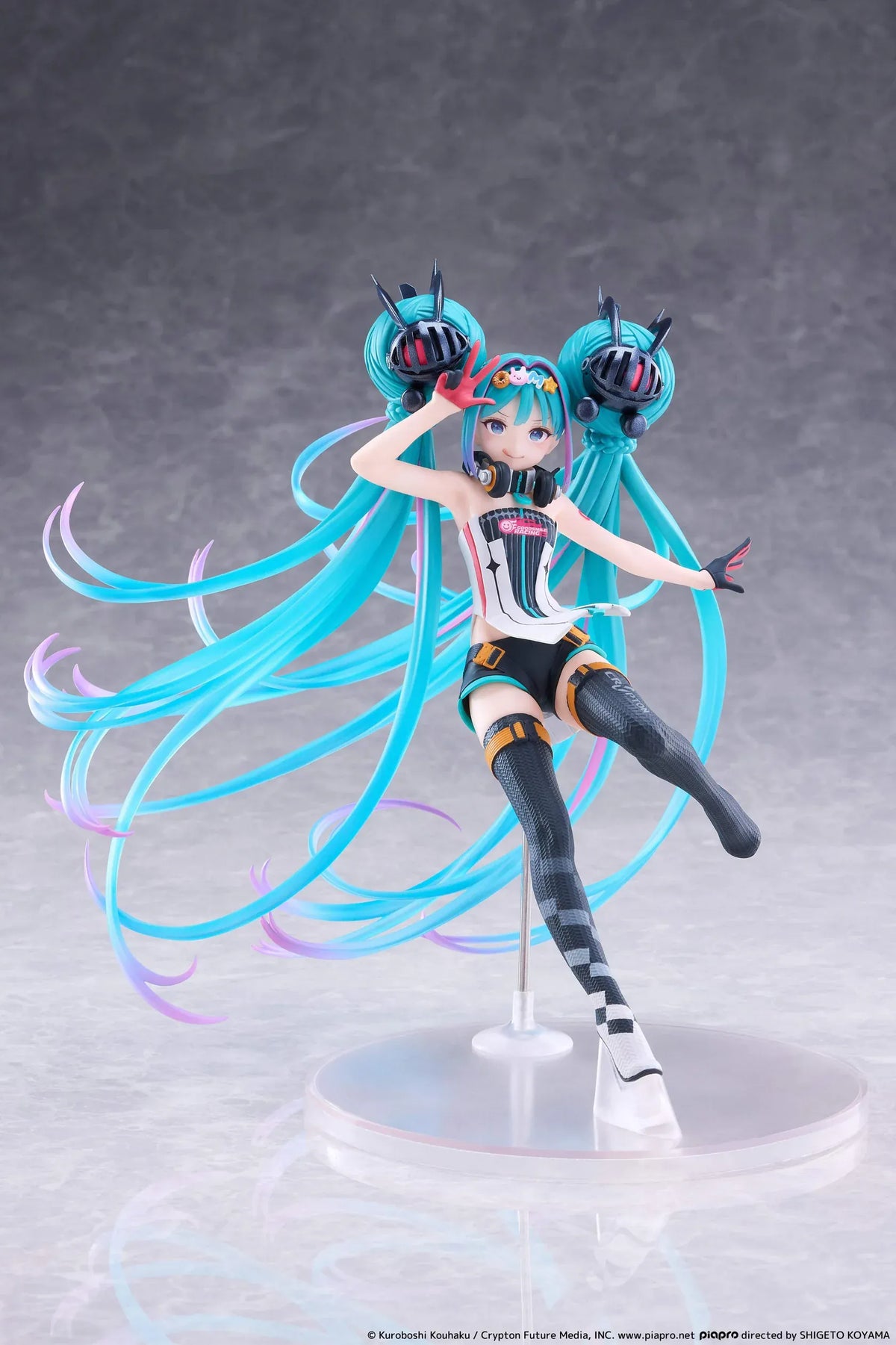 Hatsune Miku Taito Kuji Racing Miku 2026 figure wearing a futuristic racing outfit with flowing turquoise twin-tails and headphones.