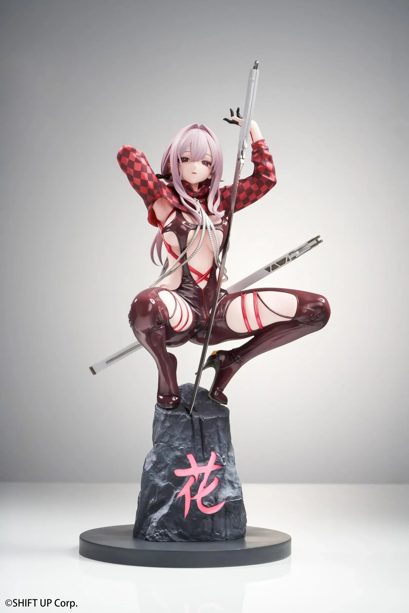 Scarlet Racer's High scale figure from Goddess of Victory: Nikke, crouching on a rocky base with weapons drawn and glossy red combat suit.