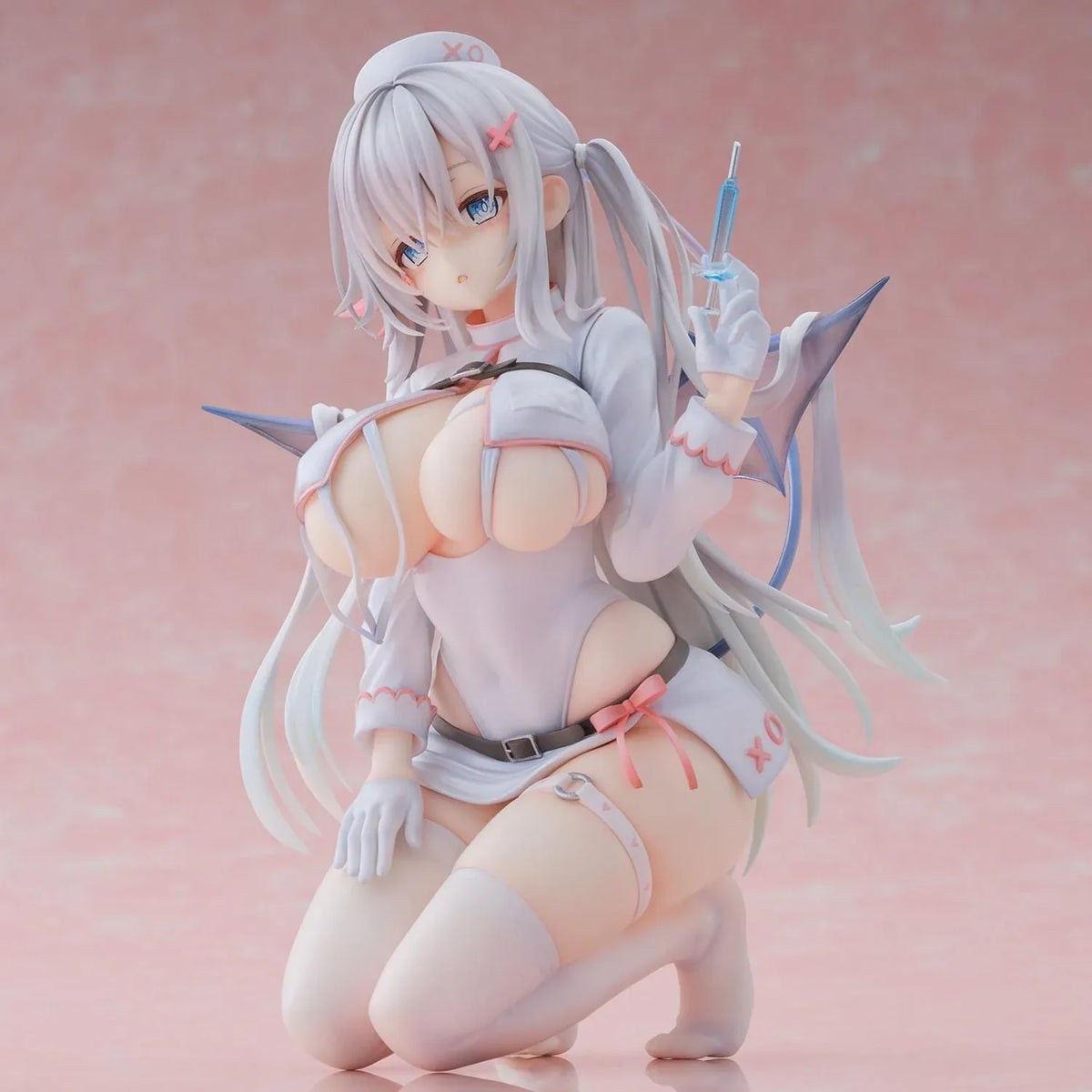 Succubus Nurse Makina figure kneeling in a white and pink nurse outfit with silver hair, batlike wings, a demon tail, and a translucent syringe.