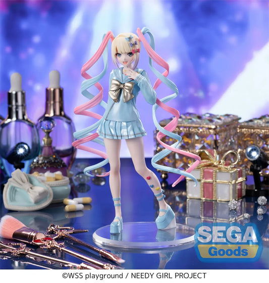 Luminasta OMGKawaiiAngel figure from Needy Streamer Overload standing on a clear base, wearing a pastel blue school outfit with gold bow and long pink-and-blue spiral twin tails, surrounded by makeup and accessories.