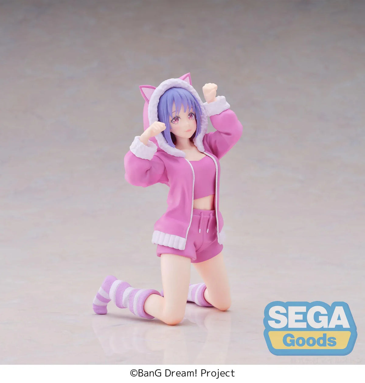BanG Dream! Nyamu Yutenji Pajama Party figure kneeling in pink pajamas with a cat-ear hood, purple hair, striped socks, and both hands raised.
