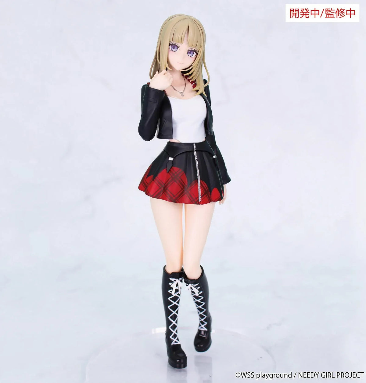 Prototype NEEDY GIRL OVERDOSE Vivit KACHE figure with blond hair, a black jacket, white top, red plaid skirt, and tall black boots with white laces.