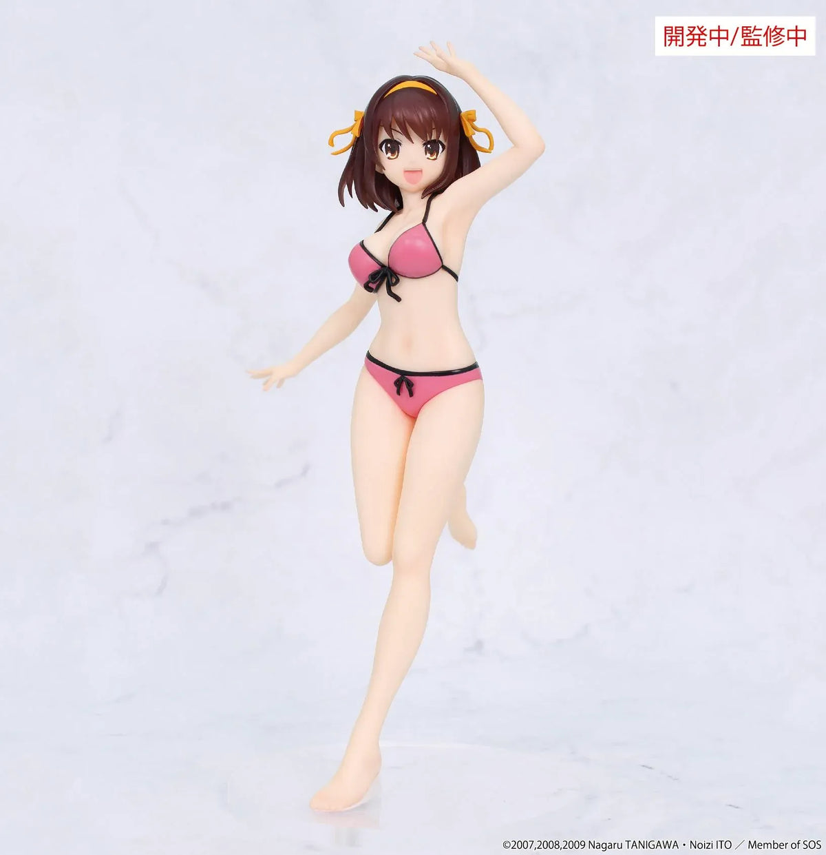 Vivit Haruhi Suzumiya figure wearing a pink swimsuit with black trim and yellow hair ribbons, smiling with one arm raised and one leg lifted.