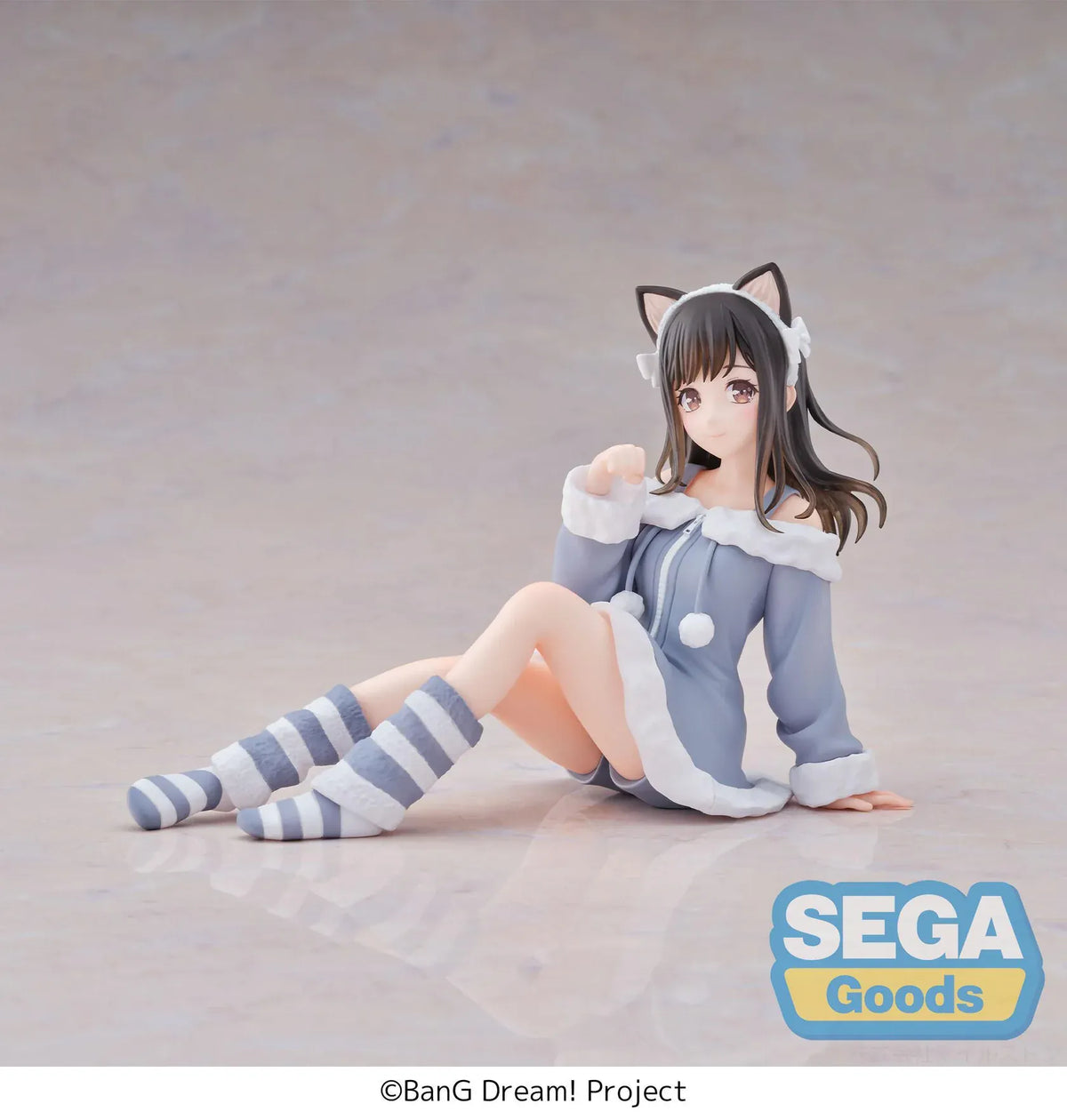 BanG Dream! Mana Sumita Pajama Party figure seated in a blue-gray outfit with white trim, cat-ear headband, striped socks, and one hand raised.