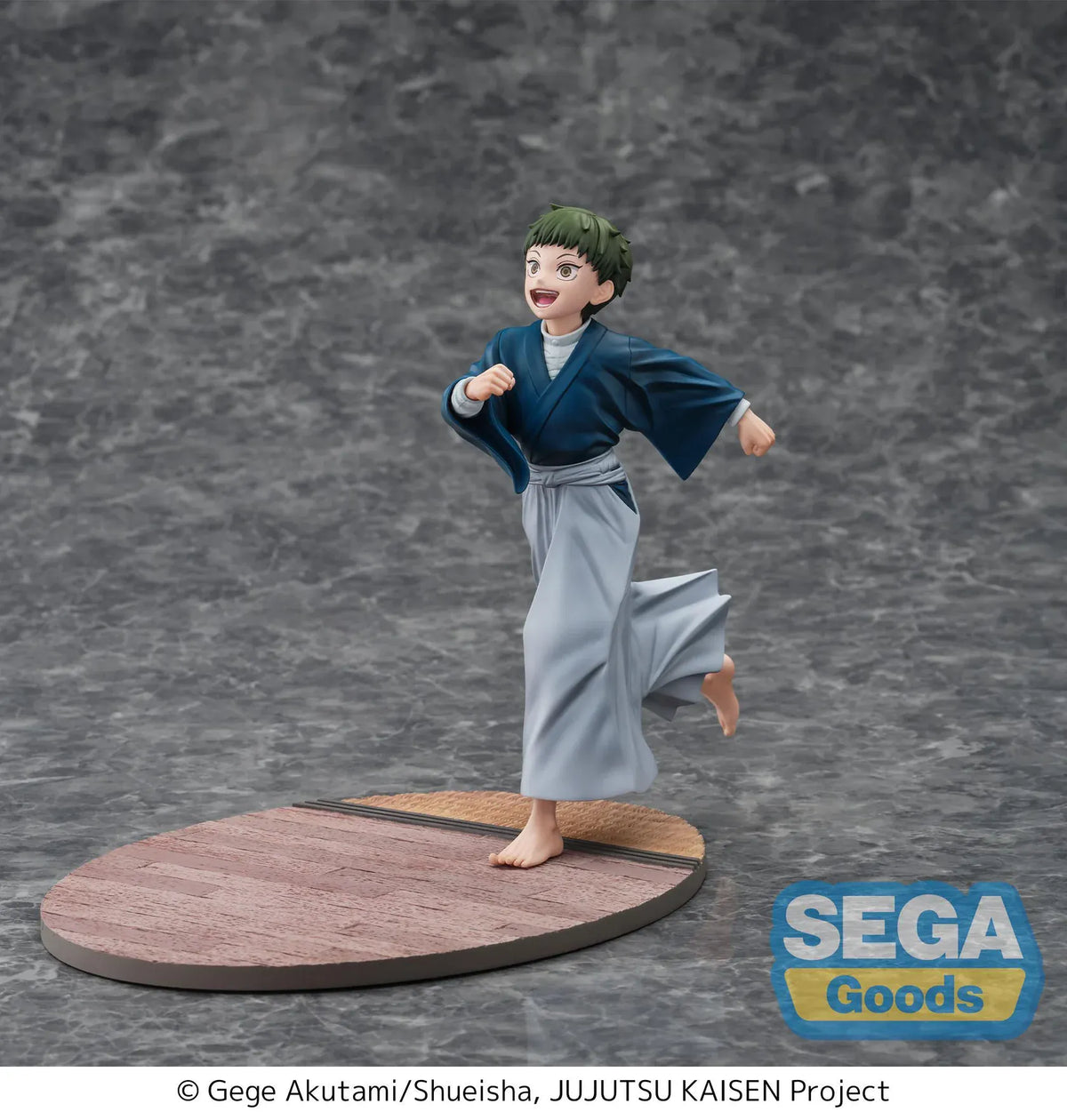 Luminasta Naoya Zen’in Childhood figure running barefoot in a blue top and gray hakama, smiling on an oval base with wood-style flooring.