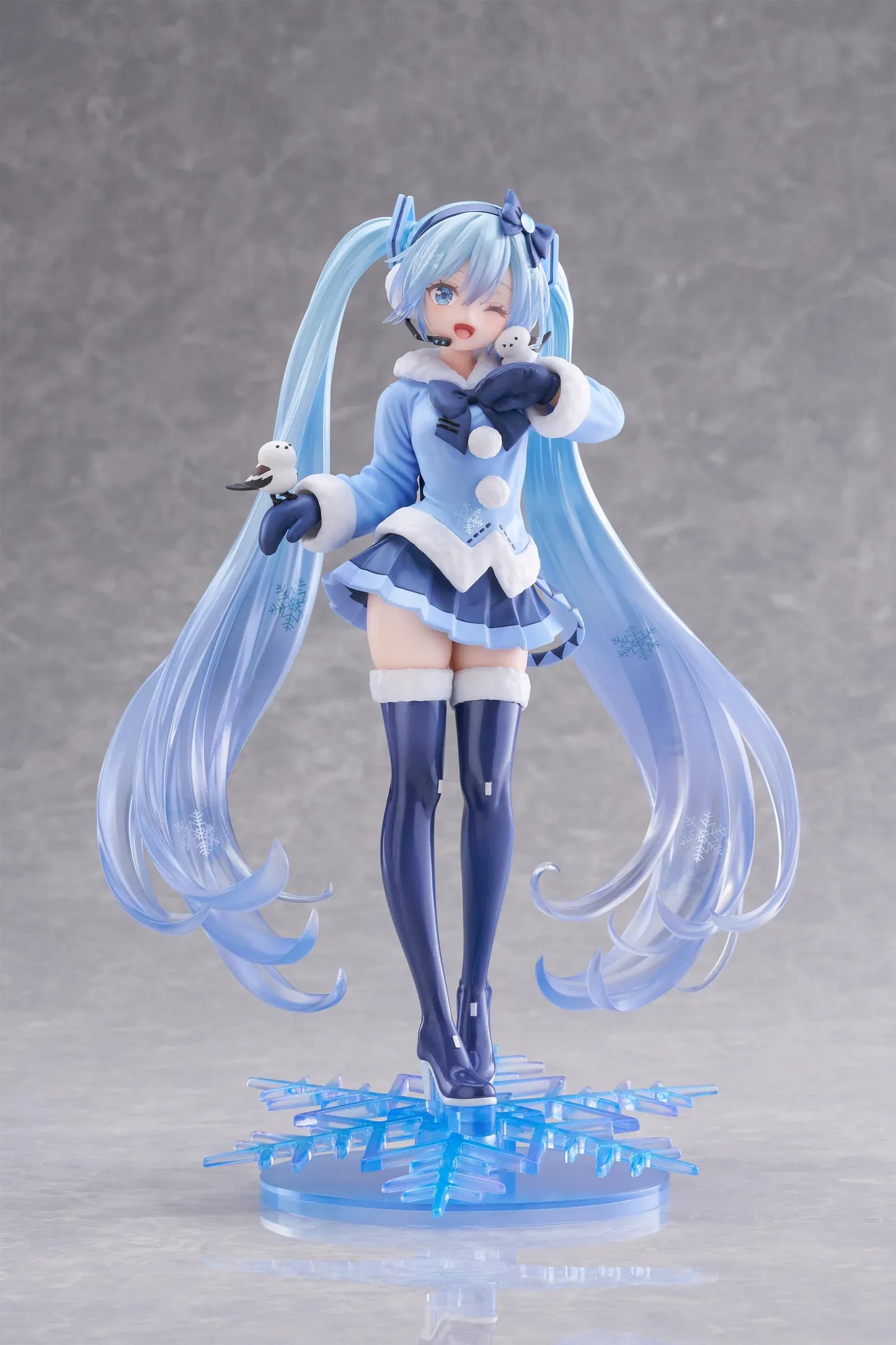 Vocaloid AMP+ Snow Miku All Stars 2012 Ver. Figure with icy blue twin-tails, winter outfit, bird details, and snowflake display base